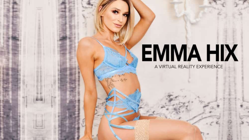 Blonde model Emma Hix posing in blue lingerie and stockings showing off tattoo